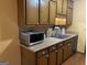 Kitchen with wooden cabinets, stainless steel microwave and a double bowl sink at 416 Winterwood Dr, Stockbridge, GA 30281