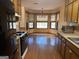 Traditional kitchen with appliances, wood cabinets, wood floors and bay window sitting area at 416 Winterwood Dr, Stockbridge, GA 30281