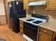 Kitchen featuring stainless steel refrigerator, gas range, and wood cabinets at 416 Winterwood Dr, Stockbridge, GA 30281