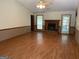 Bright living room features wood floors, fireplace, and plenty of space for furniture at 416 Winterwood Dr, Stockbridge, GA 30281