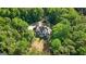 Expansive home featuring a stone patio and ample space surrounded by a dense forest at 2878 Heather Row Sw Rdg, Lilburn, GA 30047