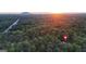 A home location hidden in the woods; sunset and mountain in the distance at 2878 Heather Row Sw Rdg, Lilburn, GA 30047