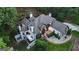 Aerial view showcases the home's well-maintained grounds, complemented by a circular driveway and lush tree coverage at 2878 Heather Row Sw Rdg, Lilburn, GA 30047