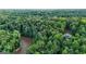 Expansive aerial view of property and mature forest with a nearby river offering both privacy and natural beauty at 2878 Heather Row Sw Rdg, Lilburn, GA 30047