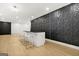 Finished basement features a bar area with modern textured wall and contemporary stools at 2878 Heather Row Sw Rdg, Lilburn, GA 30047