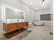 Spa-like bathroom featuring double sink vanity, modern fixtures, soaking tub, and marble accents at 2878 Heather Row Sw Rdg, Lilburn, GA 30047