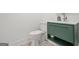 Bathroom features a sleek vanity with modern fixtures, a toilet, and tile flooring at 2878 Heather Row Sw Rdg, Lilburn, GA 30047