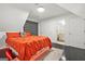 Stylish bedroom with hardwood floors, a bright orange bedspread and a view to the bath at 2878 Heather Row Sw Rdg, Lilburn, GA 30047