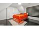 Cozy bedroom features a bright orange bedspread and custom blinds on the windows at 2878 Heather Row Sw Rdg, Lilburn, GA 30047