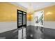 Elegant dining room with dark wood floors, gold accents, chandelier, and views of foyer at 2878 Heather Row Sw Rdg, Lilburn, GA 30047