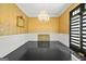 Formal dining room showcasing dark wood floors, gold wallpaper and a stunning chandelier at 2878 Heather Row Sw Rdg, Lilburn, GA 30047