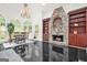 Dining room with elegant chandelier, stone fireplace, built-in shelves, and large windows at 2878 Heather Row Sw Rdg, Lilburn, GA 30047