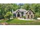 Stunning two-story home featuring stone accents, a well-manicured lawn, and a charming water fountain at 2878 Heather Row Sw Rdg, Lilburn, GA 30047