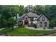 Elegant two-story home showcasing stone detailing, lush landscaping, and inviting walkway with soft lighting at 2878 Heather Row Sw Rdg, Lilburn, GA 30047