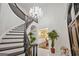 Elegant foyer with a curved staircase, decorative chandelier and arched doorway at 2878 Heather Row Sw Rdg, Lilburn, GA 30047
