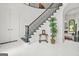 Foyer with black and white tile, dark wood stairs, and an arched doorway to the living room at 2878 Heather Row Sw Rdg, Lilburn, GA 30047