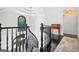 Hallway with black staircase, decorative chandelier, and view to second story arched window at 2878 Heather Row Sw Rdg, Lilburn, GA 30047