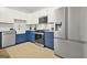 Modern kitchen boasting two-tone cabinets, stainless steel appliances, and modern fixtures at 2878 Heather Row Sw Rdg, Lilburn, GA 30047