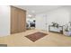 Modern living room featuring a wood-slat wall and an entryway to a bright white kitchen at 2878 Heather Row Sw Rdg, Lilburn, GA 30047
