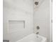 Modern shower with white large format tile, a sleek shower head and a built-in niche at 2878 Heather Row Sw Rdg, Lilburn, GA 30047