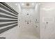 Luxurious marble shower with modern shower system, accent lighting, and window feature at 2878 Heather Row Sw Rdg, Lilburn, GA 30047
