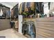 Organized walk-in closet featuring custom shelving, hanging racks, and ample storage for clothes at 2878 Heather Row Sw Rdg, Lilburn, GA 30047
