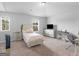 Bright bedroom featuring neutral walls, carpet, and a cozy bed, complemented by ample natural light and a TV at 445 Sawmill Trce, Hampton, GA 30228