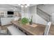 Elegant dining room features a stylish chandelier, wood-look floors, and an open layout at 445 Sawmill Trce, Hampton, GA 30228