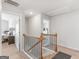 Hallway with wooden rails and a door to a bedroom in a carpeted area at 445 Sawmill Trce, Hampton, GA 30228