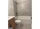 Modern bathroom with sleek gray tile, a shower-tub combination, and elegant fixtures at 129 Silvercrest Dr # 57, Acworth, GA 30101