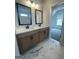 Well-lit bathroom with double sinks, and marble tile and an opening to an adjacent room with natural light at 129 Silvercrest Dr # 57, Acworth, GA 30101