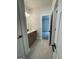 Well-lit bathroom featuring a vanity with modern fixtures and a view into the next room through an open door at 129 Silvercrest Dr # 57, Acworth, GA 30101