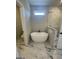 Modern bathroom featuring a sleek freestanding tub, marble tile flooring, and a minimalist aesthetic at 129 Silvercrest Dr # 57, Acworth, GA 30101