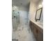 Luxurious bathroom featuring marble floors, double vanity, glass enclosed shower with seat, and natural light at 129 Silvercrest Dr # 57, Acworth, GA 30101
