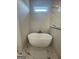 Contemporary bathroom with a freestanding tub and a small window for natural light, creating a spa-like atmosphere at 129 Silvercrest Dr # 57, Acworth, GA 30101