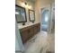 Well-lit bathroom with double sinks, and marble tile and an opening to an adjacent room with natural light at 129 Silvercrest Dr # 57, Acworth, GA 30101