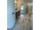 Bathroom featuring marble floors, a double vanity, and natural light from the window to the hallway at 129 Silvercrest Dr # 57, Acworth, GA 30101
