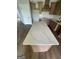 Close-up of kitchen island with white countertops and wooden cabinets at 129 Silvercrest Dr # 57, Acworth, GA 30101