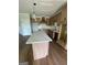 Kitchen boasts an island, light wood cabinets, pendant lighting, and modern features at 129 Silvercrest Dr # 57, Acworth, GA 30101