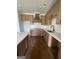 Bright kitchen featuring stainless steel sink, wooden cabinets, and white countertops at 129 Silvercrest Dr # 57, Acworth, GA 30101