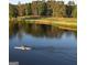 Scenic view of a serene lake with a person kayaking and lush greenery reflecting on the water at 129 Silvercrest Dr # 57, Acworth, GA 30101