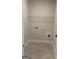 A practical laundry room features tile floors and utility connections for easy laundry tasks at 129 Silvercrest Dr # 57, Acworth, GA 30101