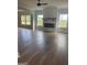 Open living room with fireplace and hardwood floors, showcasing natural light and modern fixtures at 129 Silvercrest Dr # 57, Acworth, GA 30101