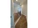 Hardwood staircase with black metal railings and light wood banister at 129 Silvercrest Dr # 57, Acworth, GA 30101