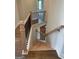 Hardwood staircase with black metal railings and light wood banister at 129 Silvercrest Dr # 57, Acworth, GA 30101