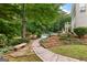 Backyard landscape with a brick pathway leading to the pool at 134 Mellington Ln, Peachtree City, GA 30269