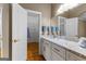 Bathroom vanity with marble countertop, white cabinets, and walk-in closet at 134 Mellington Ln, Peachtree City, GA 30269