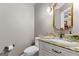 Powder room featuring custom vanity, sink with granite countertop, and classic fixtures at 134 Mellington Ln, Peachtree City, GA 30269