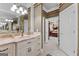 Bathroom with marble vanity and an open doorway to a bedroom with a luxurious four-poster bed at 134 Mellington Ln, Peachtree City, GA 30269