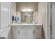 Bathroom vanity with marble countertop, white cabinets, and a large mirror at 134 Mellington Ln, Peachtree City, GA 30269